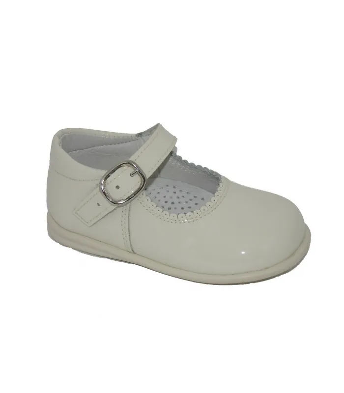 Beige patent leather Mary Janes.